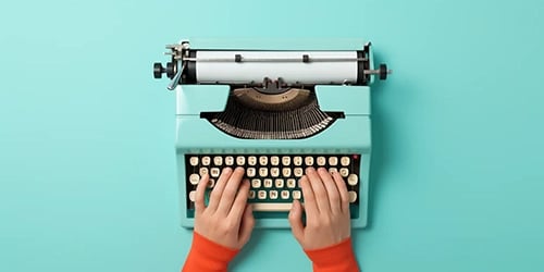 Zwei Hände tippen auf einer alten Schreibmaschine Englische Abkürzungen