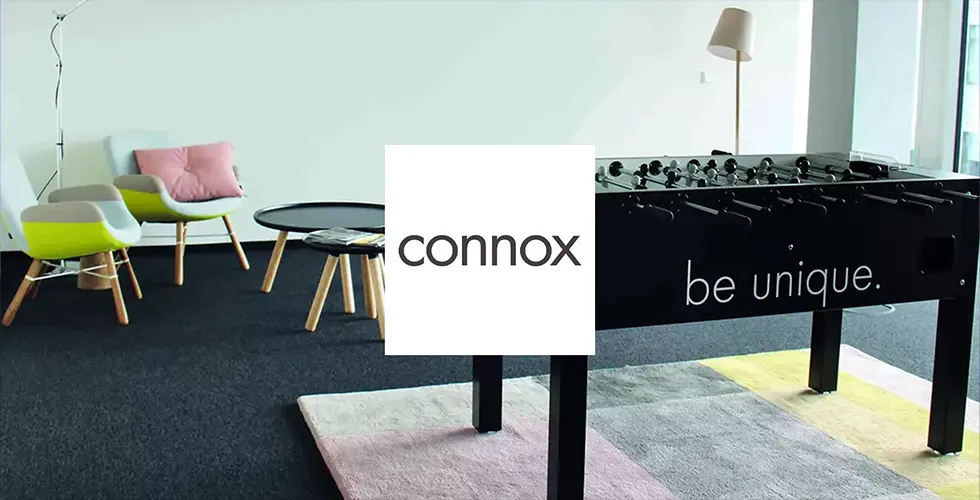 The connox logo in front of a room furnished with connox furniture.