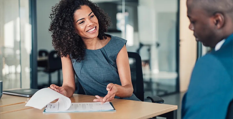A young woman explains the advantages of a financial translation to a client.