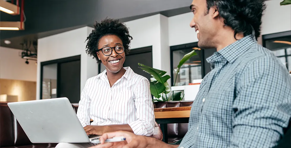 Two colleagues sit together and plan a marketing translation.