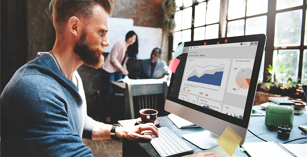 An employee looks at SEO statistics on his computer