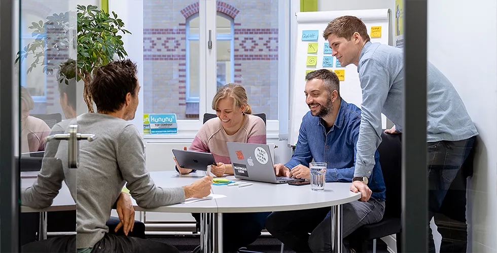Four members of the tolingo team in a meeting.