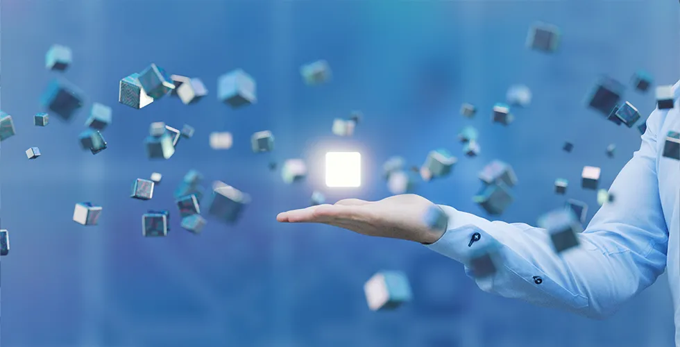 A luminous cube floats above a hand. Other cubes hover around the hand.