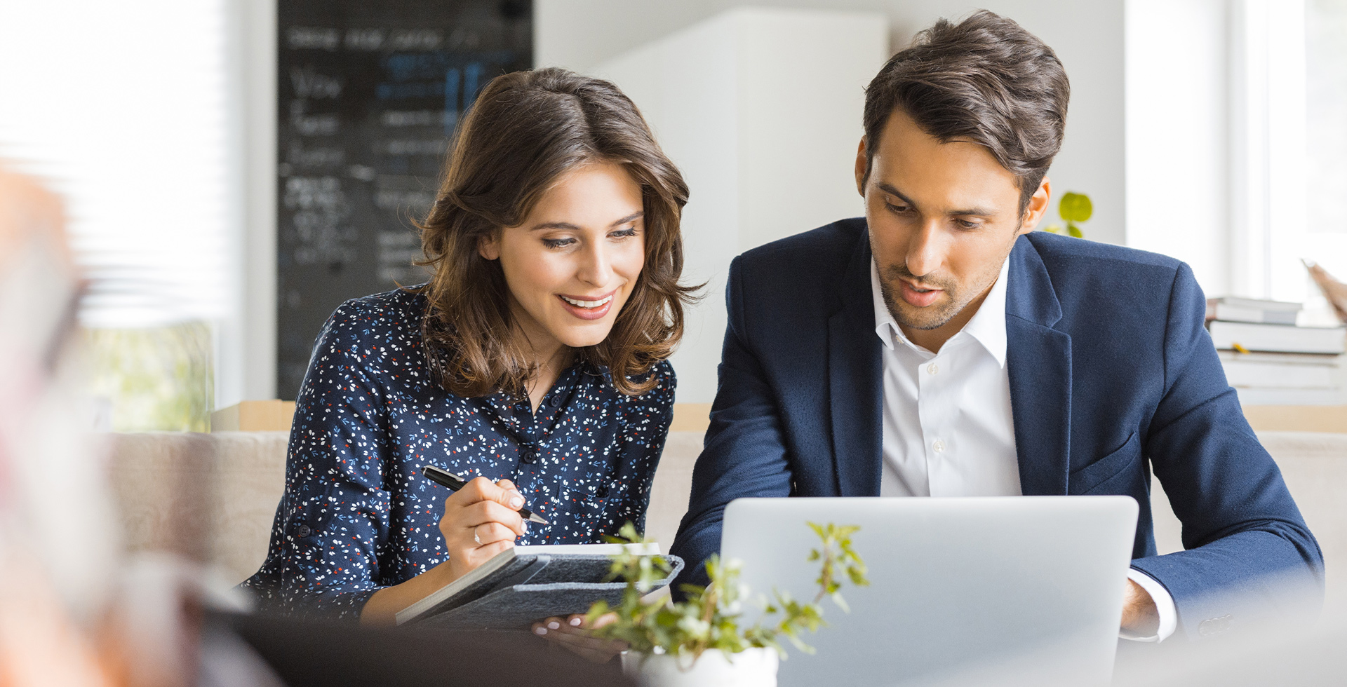 Man and woman at laptop, smiling at the tips for international job applications